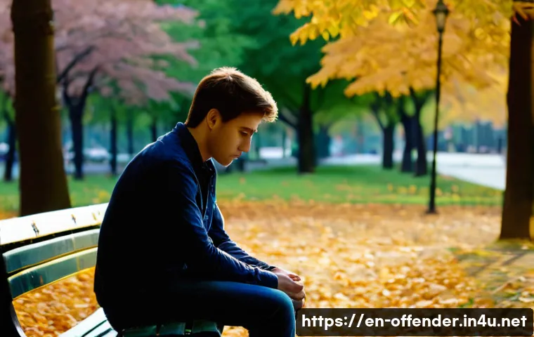 범죄자의 자수 동기 연구 - A somber, introspective scene of a young adult man sitting alone on a park bench at dusk, head bowed...